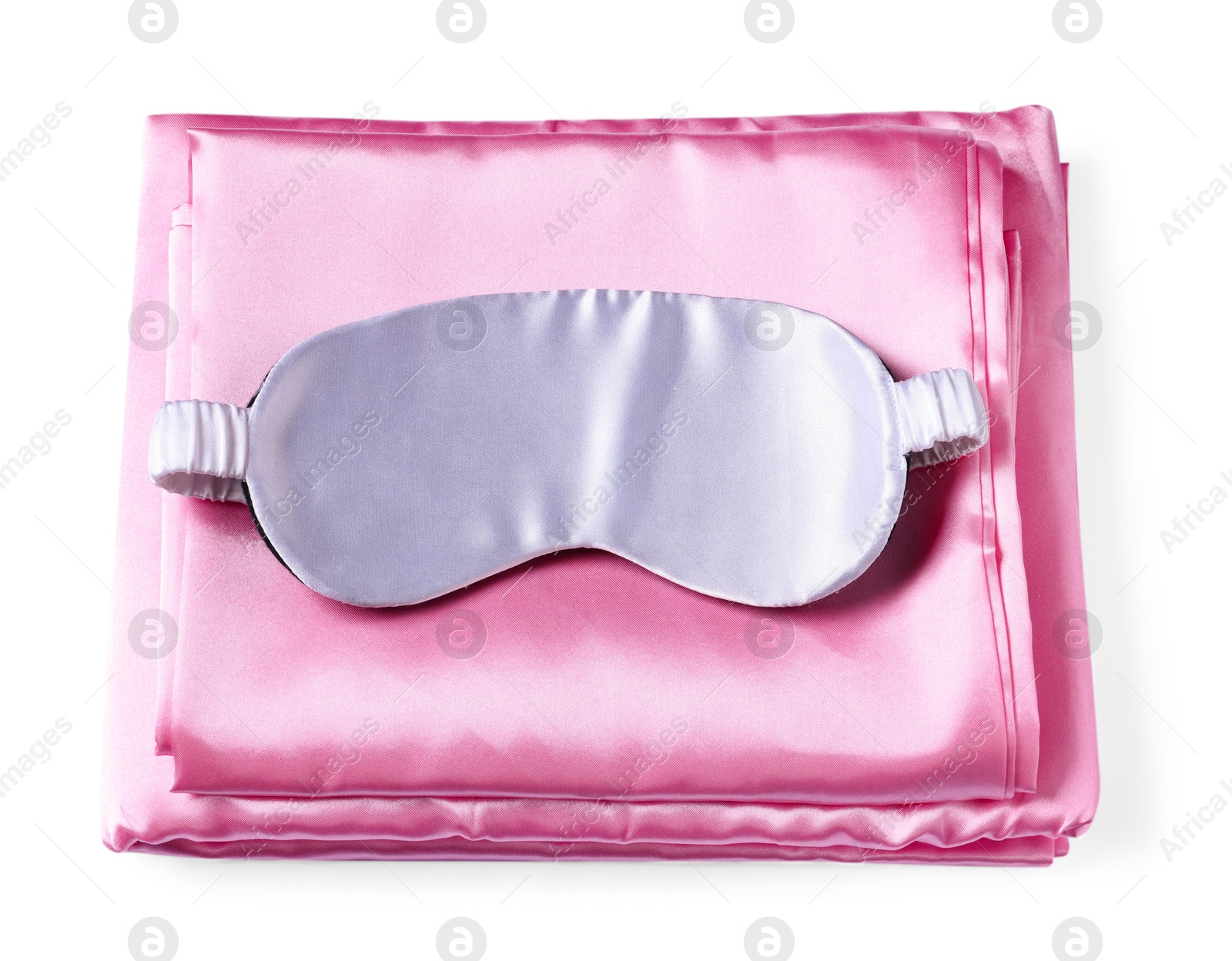 Photo of Silky bed linens and sleeping mask on white background, top view