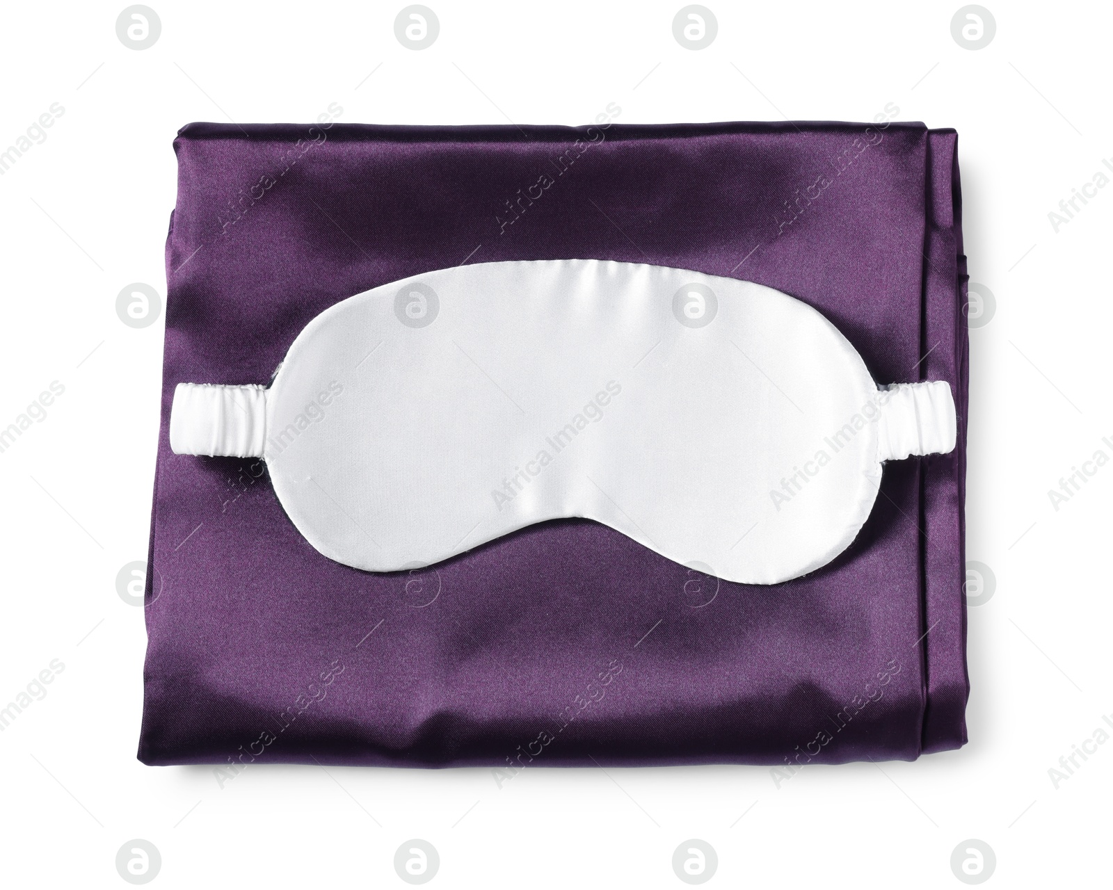 Silky bed linens and sleeping mask on white background, top view Photo of Silky bed linens and sleeping mask on white background, top view