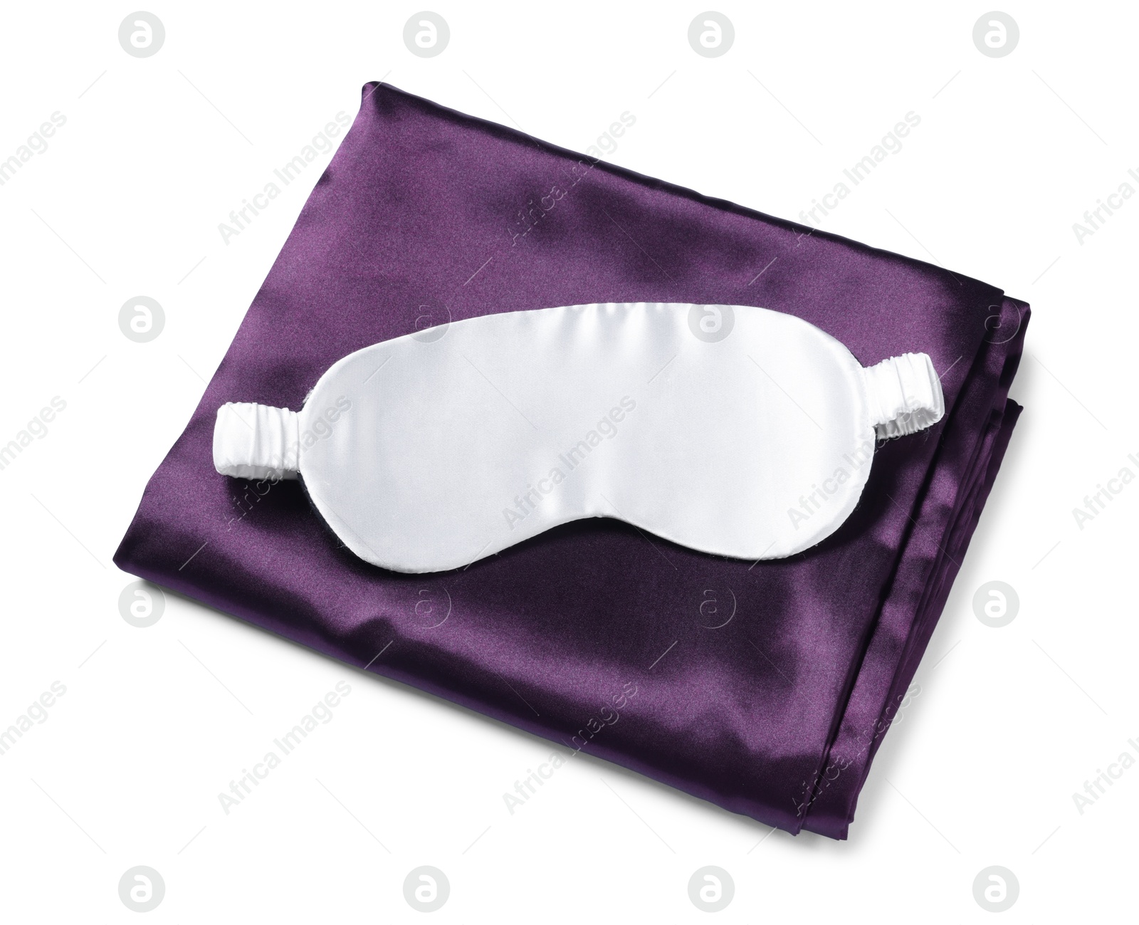 Silky bed linens and sleeping mask on white background, top view Photo of Silky bed linens and sleeping mask on white background, top view