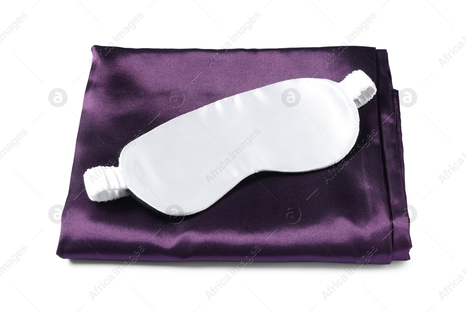 Silky bed linens and sleeping mask on white background Photo of Silky bed linens and sleeping mask on white background