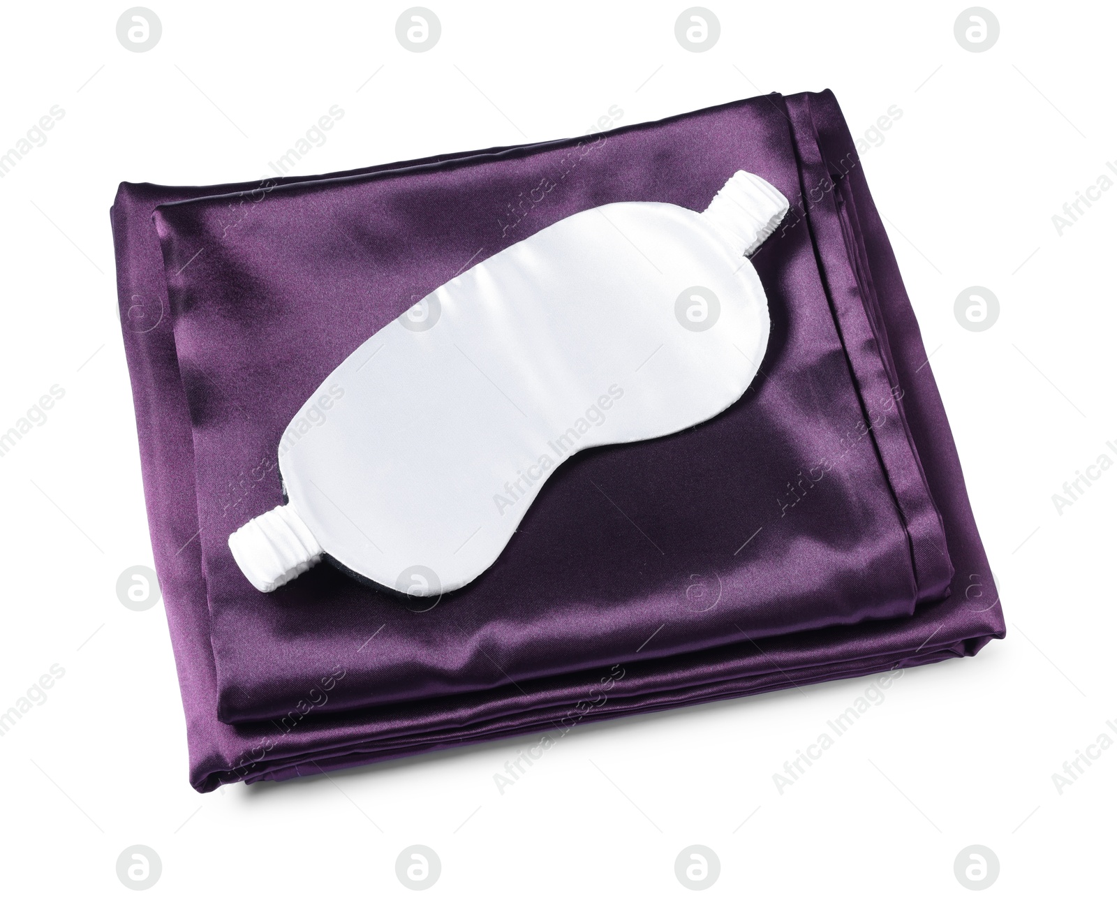 Silky bed linens and sleeping mask on white background Photo of Silky bed linens and sleeping mask on white background