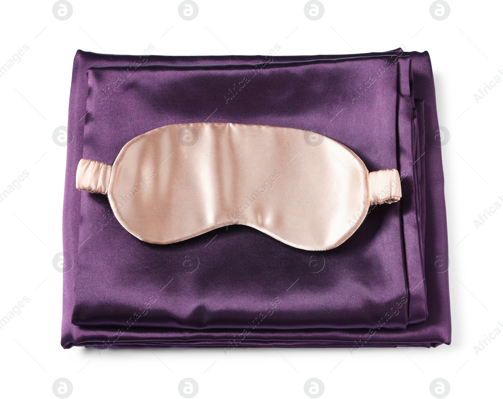Silky bed linens and sleeping mask on white background, top view Photo of Silky bed linens and sleeping mask on white background, top view