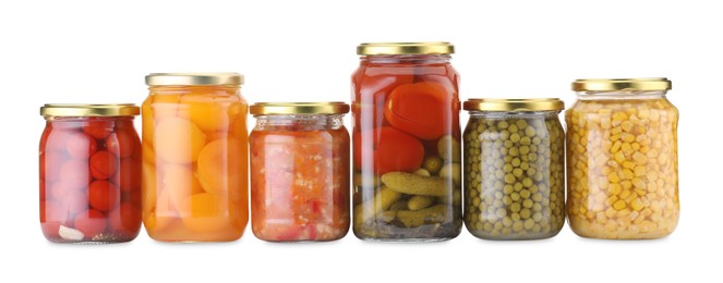 Photo of Many jars with different pickled products isolated on white