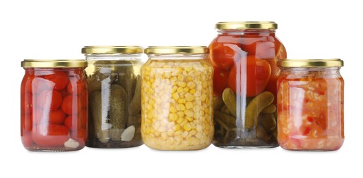 Photo of Many jars with different pickled products isolated on white