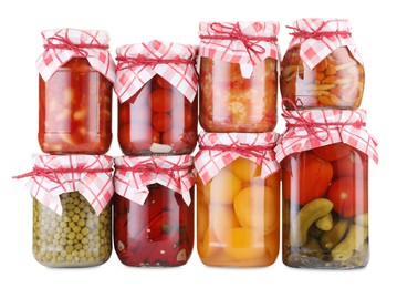 Photo of Many jars with different pickled products isolated on white