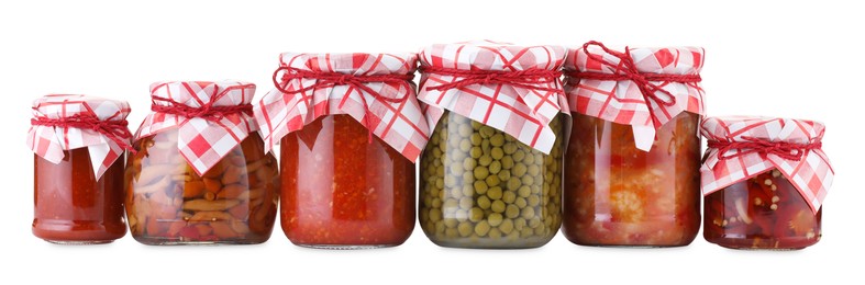 Photo of Many jars with different pickled products isolated on white