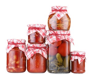 Photo of Many jars with different pickled products isolated on white