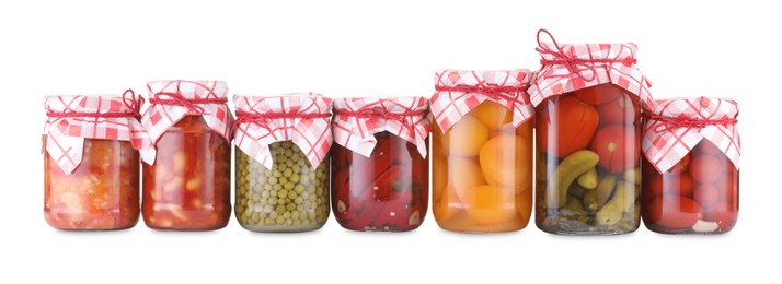 Photo of Many jars with different pickled products isolated on white