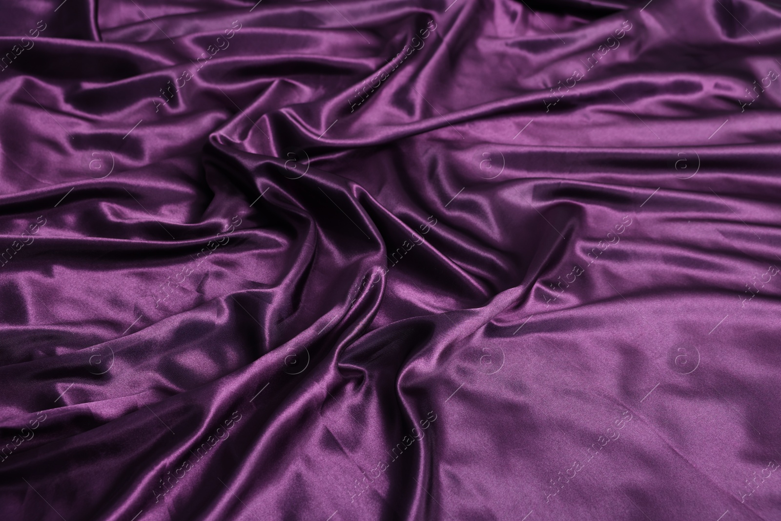 Luxury purple silk bed linens as background, closeup Photo of Luxury purple silk bed linens as background, closeup