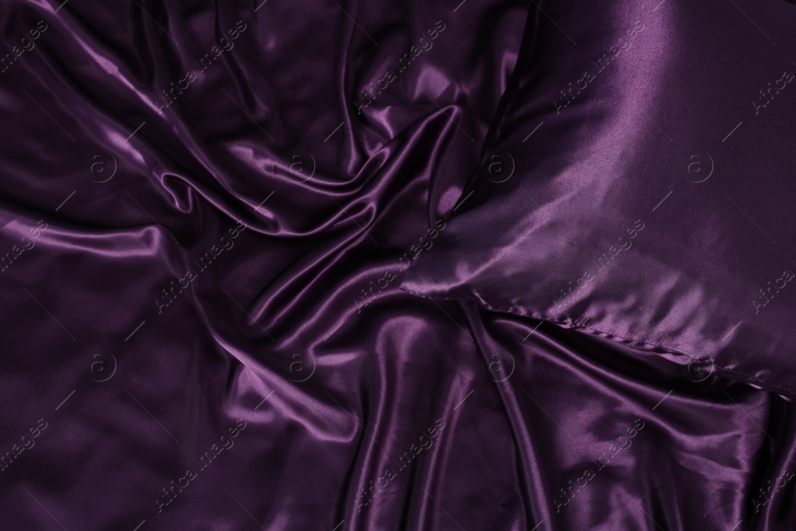 Luxury purple silk bed linens as background, top view Photo of Luxury purple silk bed linens as background, top view