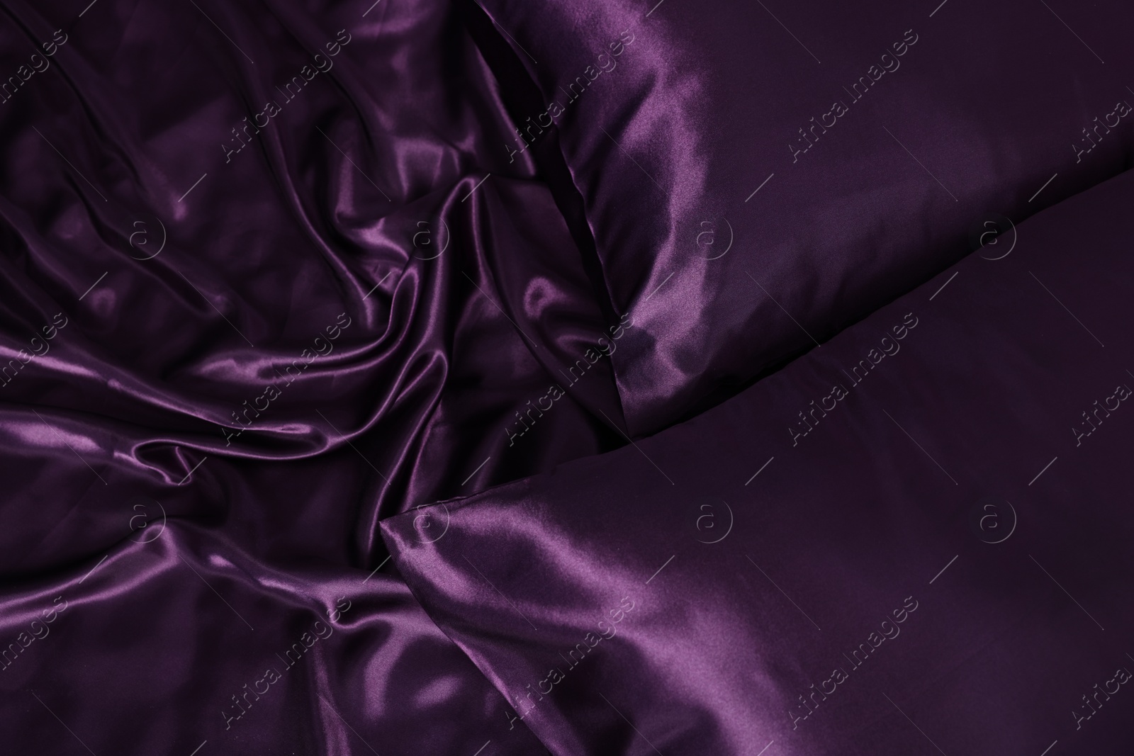 Luxury purple silk bed linens as background, top view Photo of Luxury purple silk bed linens as background, top view