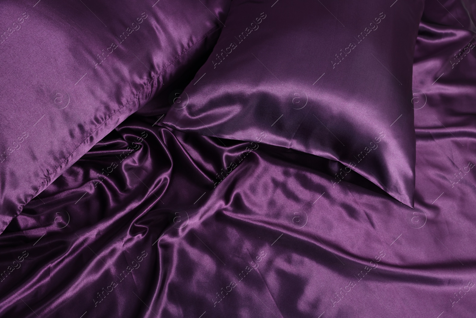 Luxury purple silk bed linens as background, above view Photo of Luxury purple silk bed linens as background, above view