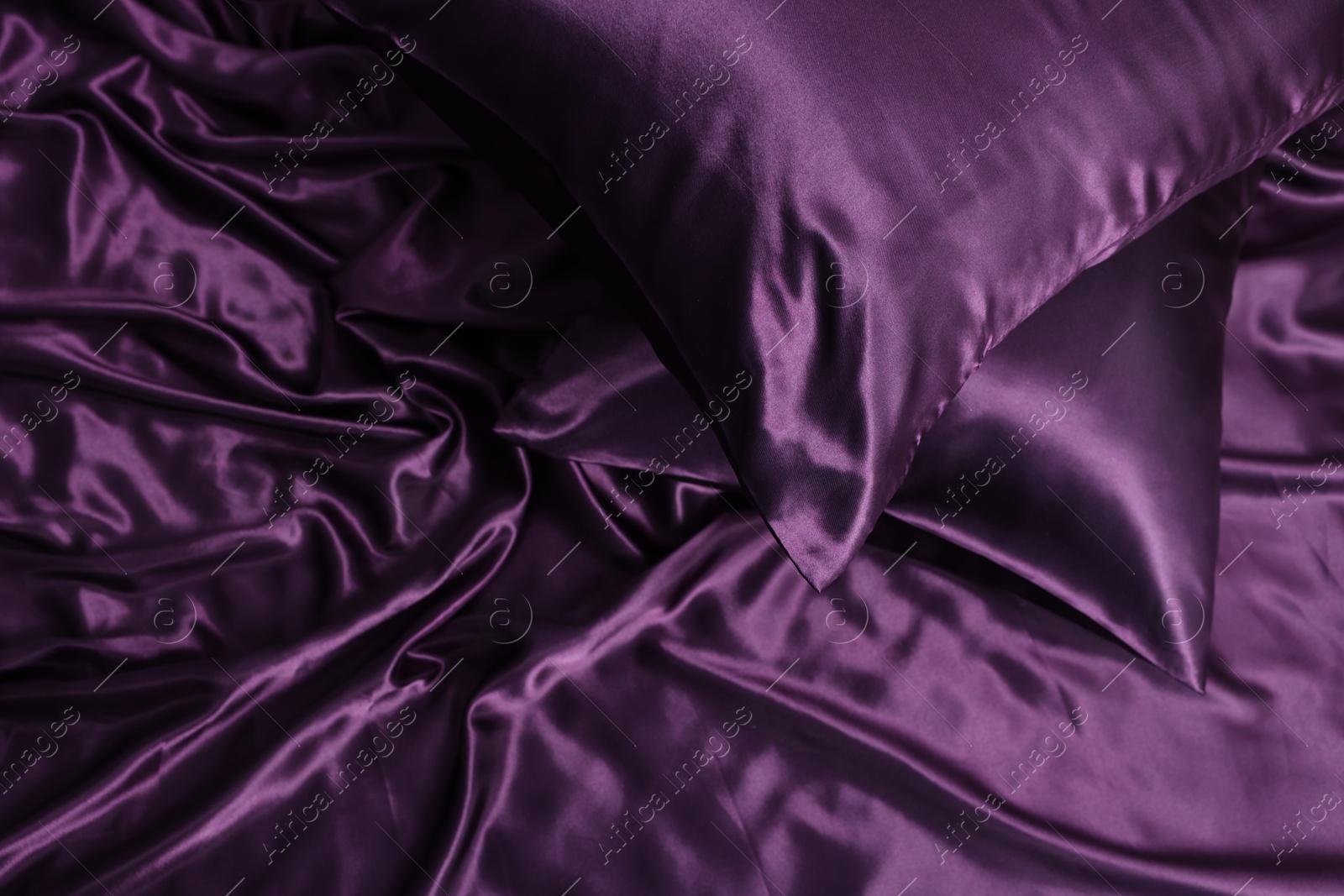 Luxury purple silk bed linens as background, top view Photo of Luxury purple silk bed linens as background, top view