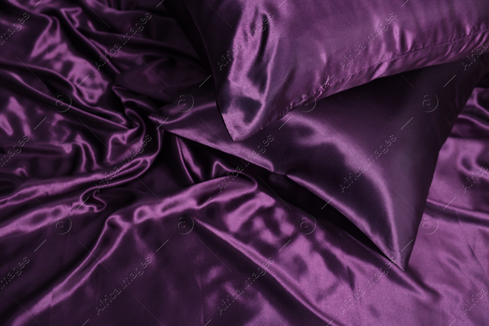 Luxury purple silk bed linens as background, top view Photo of Luxury purple silk bed linens as background, top view