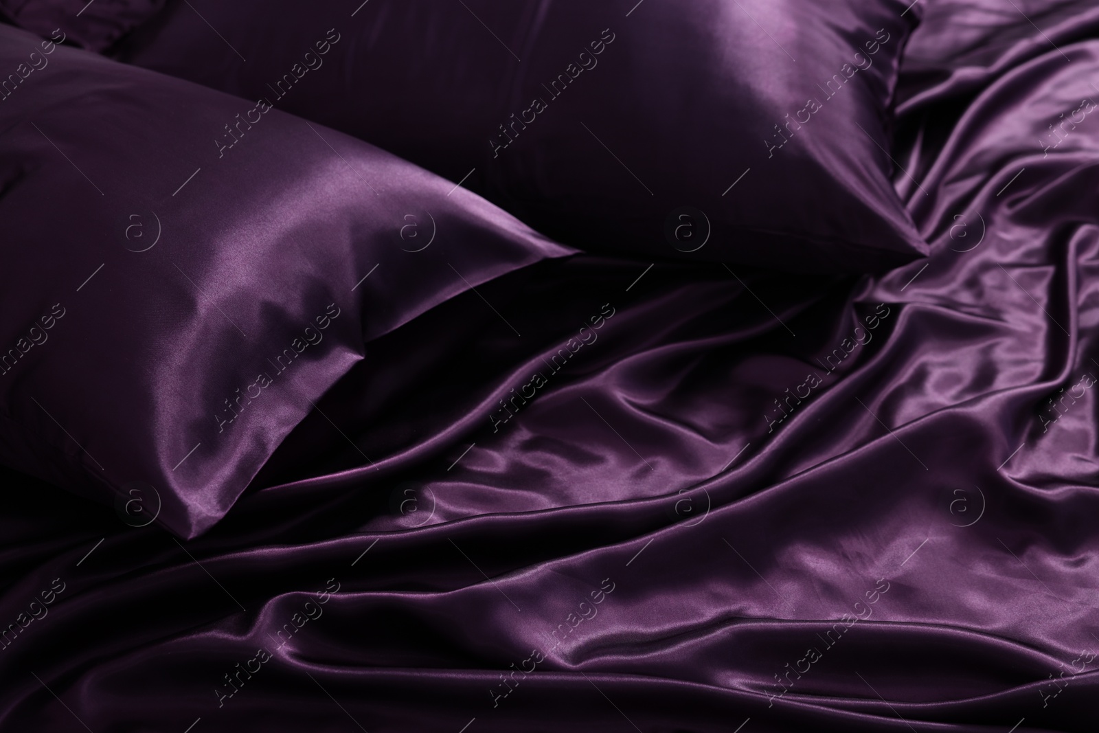 Luxury purple silk bed linens as background, closeup Photo of Luxury purple silk bed linens as background, closeup