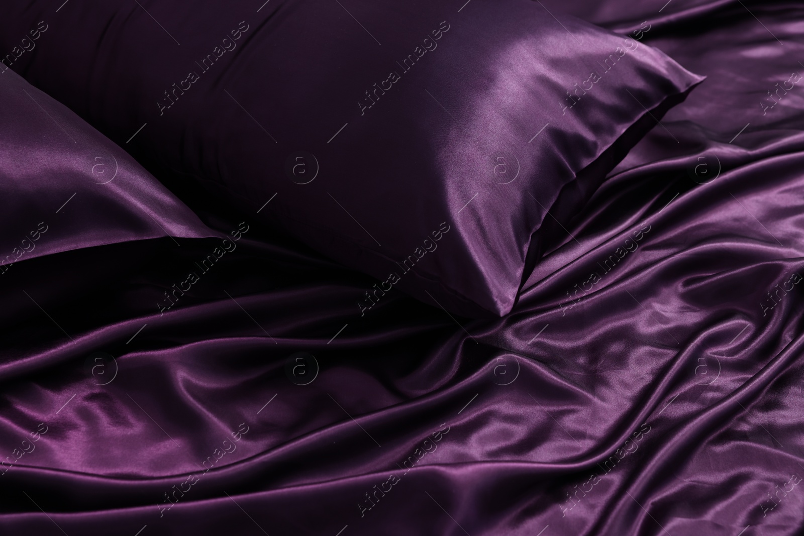 Luxury purple silk bed linens as background, closeup Photo of Luxury purple silk bed linens as background, closeup