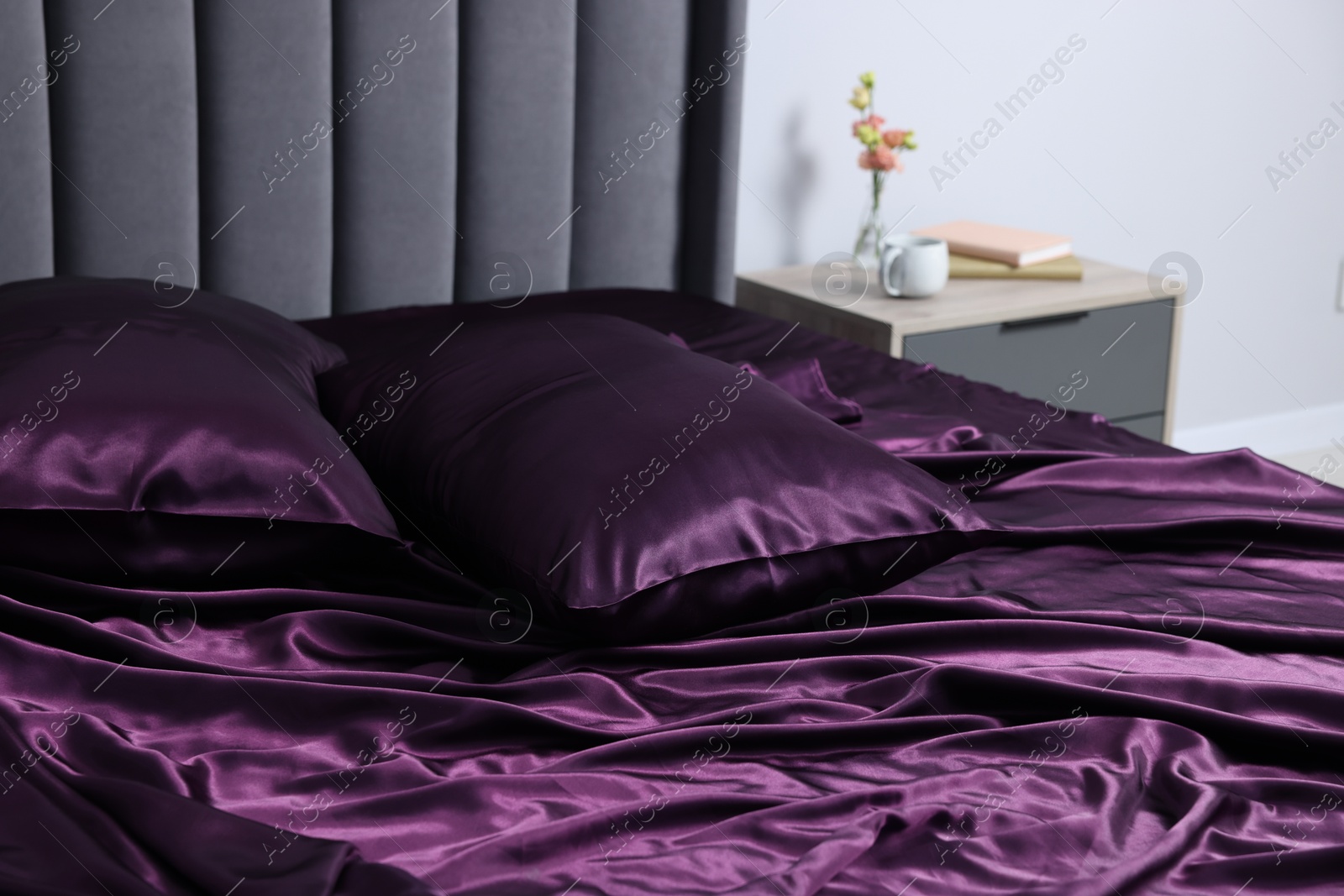 Luxury silk linens on bed at home Photo of Luxury silk linens on bed at home