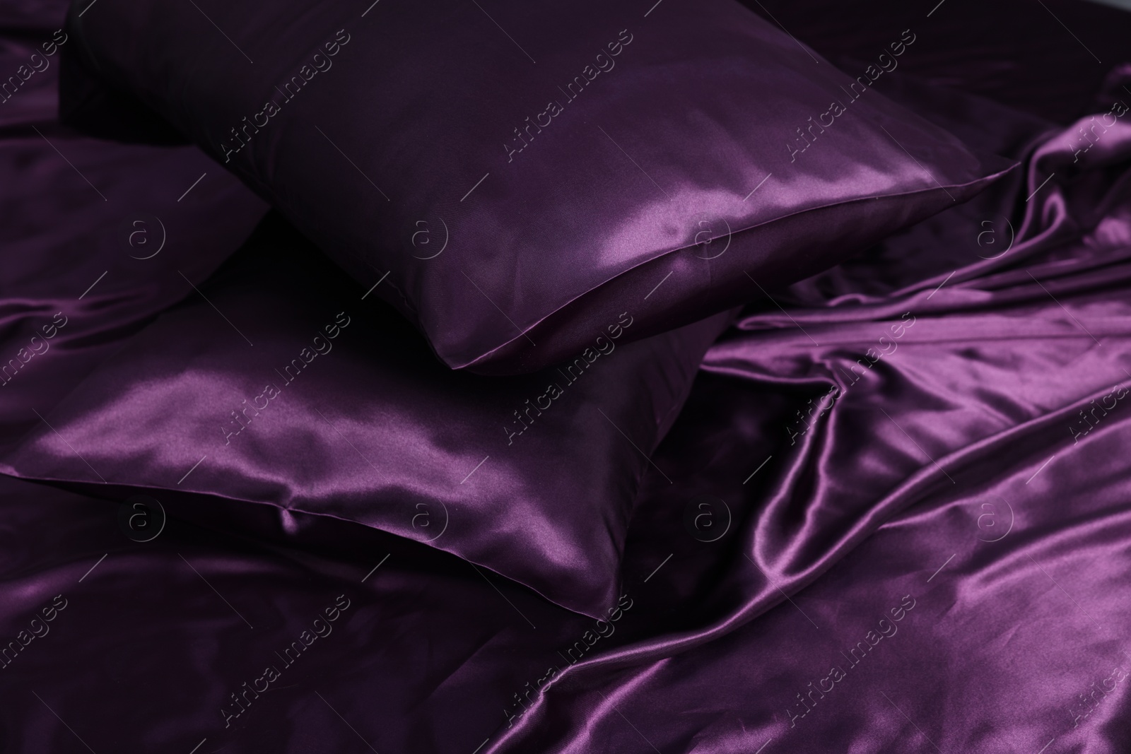 Luxury purple silk bed linens as background, closeup Photo of Luxury purple silk bed linens as background, closeup