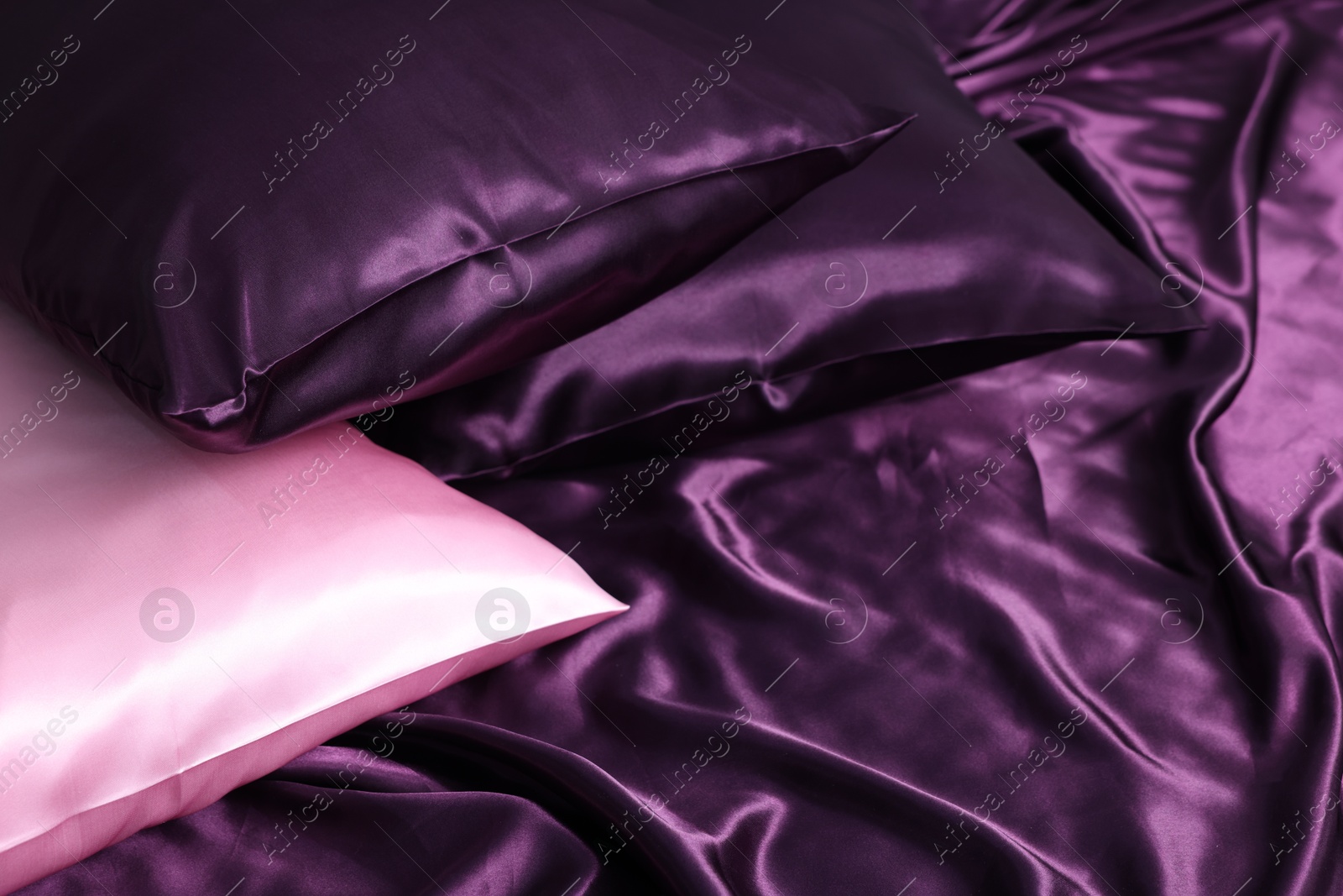 Luxury silk bed linens and pillows, closeup Photo of Luxury silk bed linens and pillows, closeup