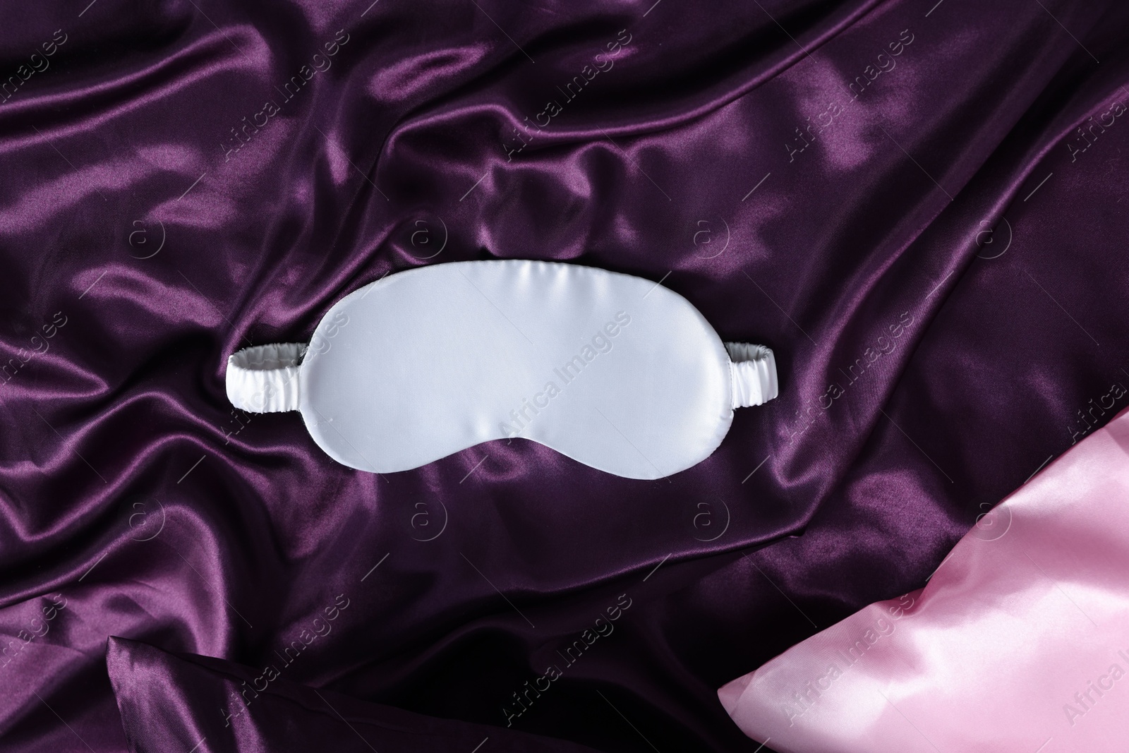 Photo of Luxury silk bed linens and sleep mask, top view