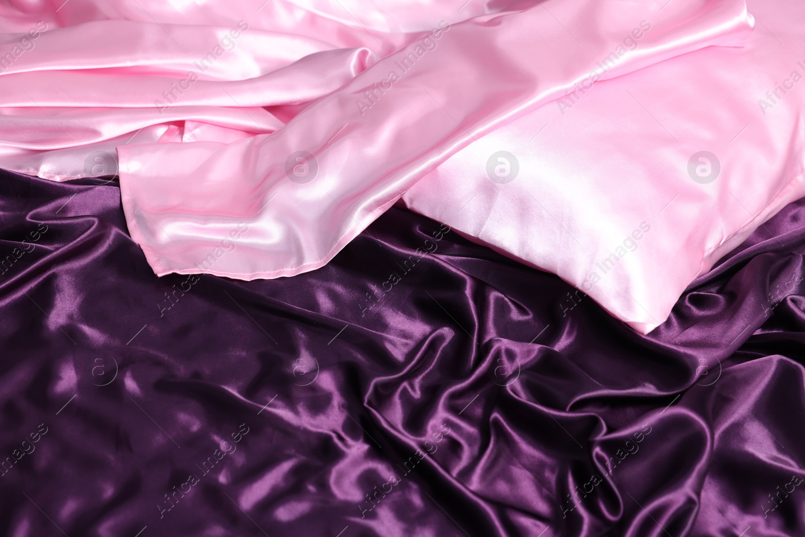 Luxury silk bed linens and pillow, closeup Photo of Luxury silk bed linens and pillow, closeup