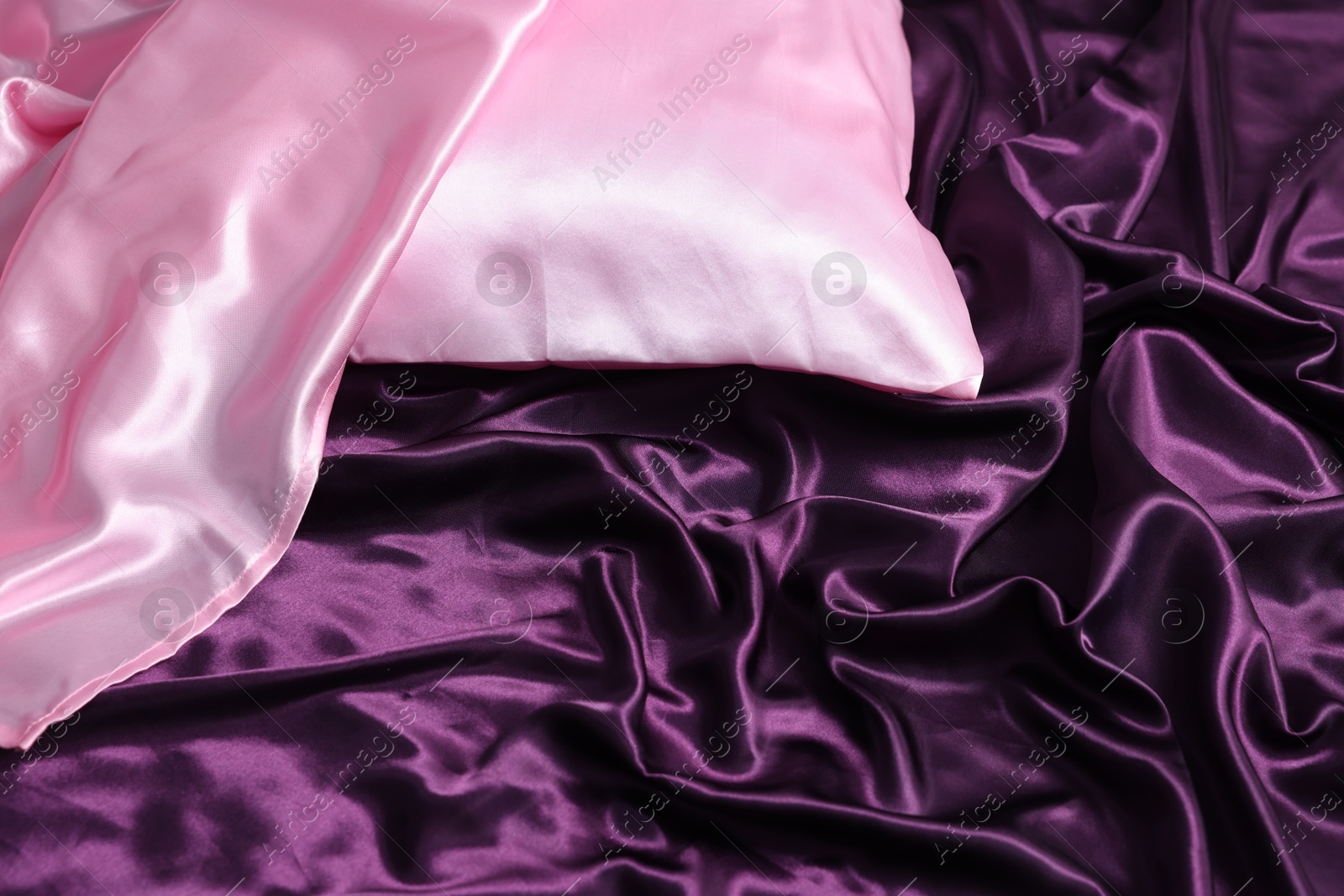 Luxury silk bed linens and pillow, closeup Photo of Luxury silk bed linens and pillow, closeup