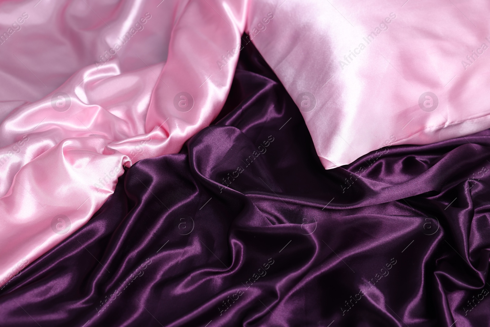 Luxury silk bed linens and pillow, closeup Photo of Luxury silk bed linens and pillow, closeup