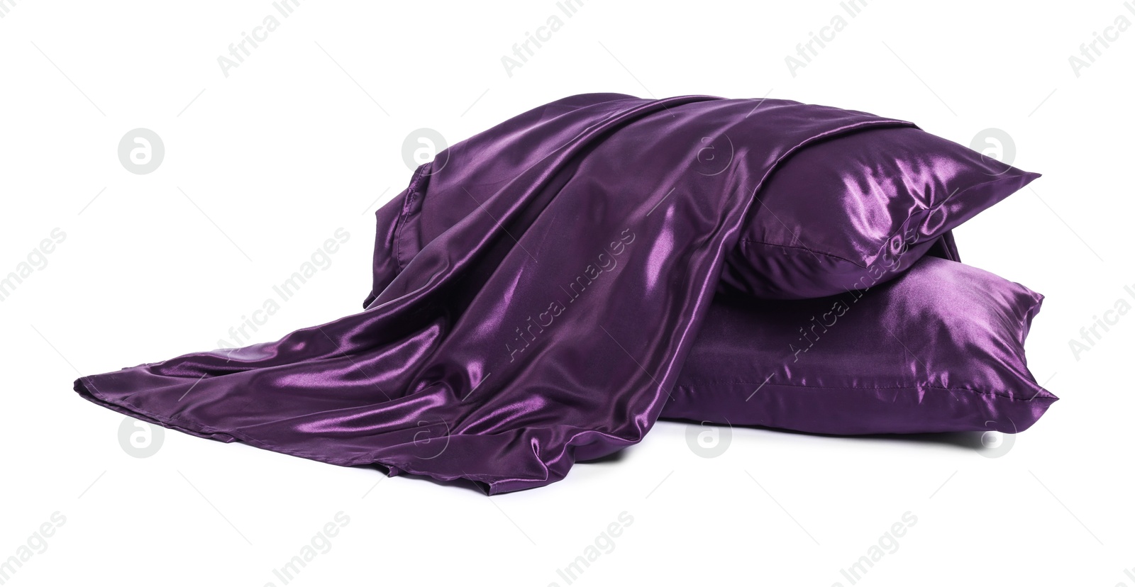 Pillows and silk bed linens isolated on white Photo of Pillows and silk bed linens isolated on white