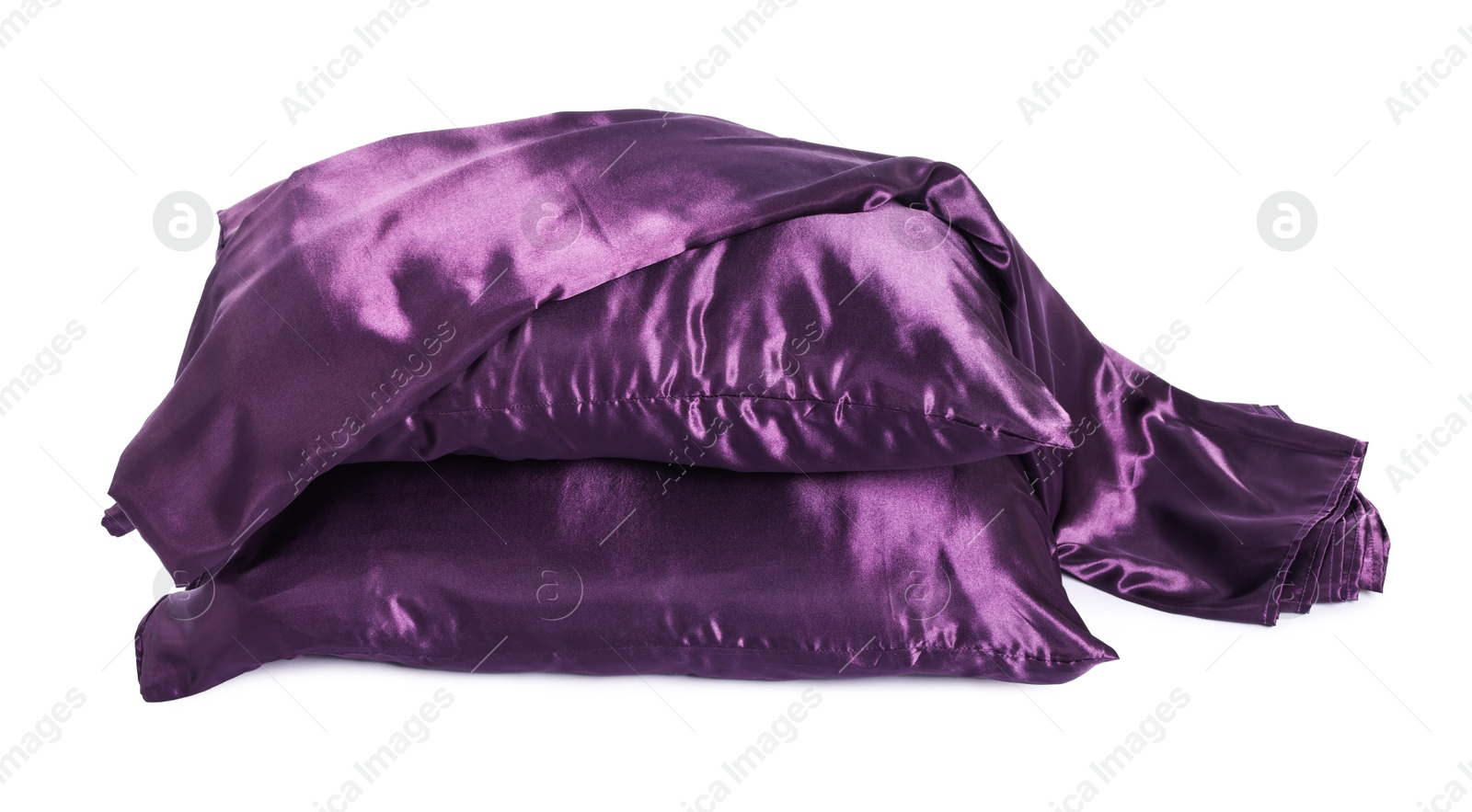Pillows and silk bed linens isolated on white Photo of Pillows and silk bed linens isolated on white