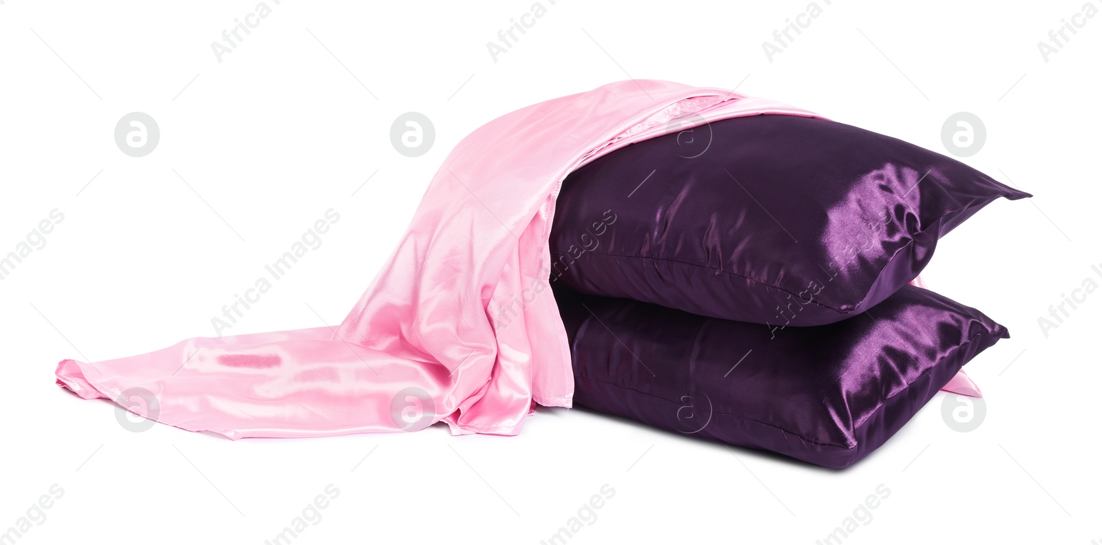 Pillows and silk bed linens isolated on white Photo of Pillows and silk bed linens isolated on white