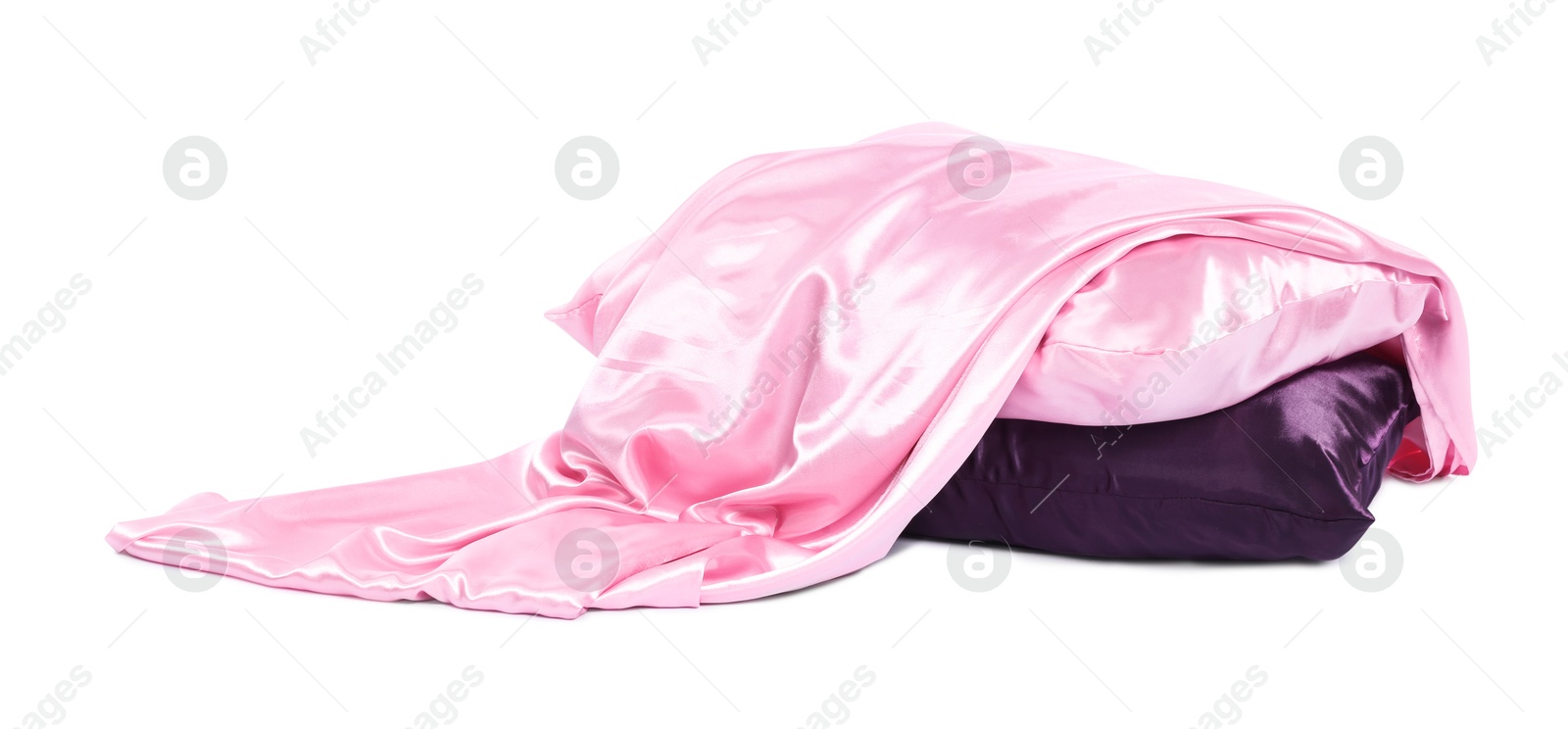 Pillows and silk bed linens isolated on white Photo of Pillows and silk bed linens isolated on white