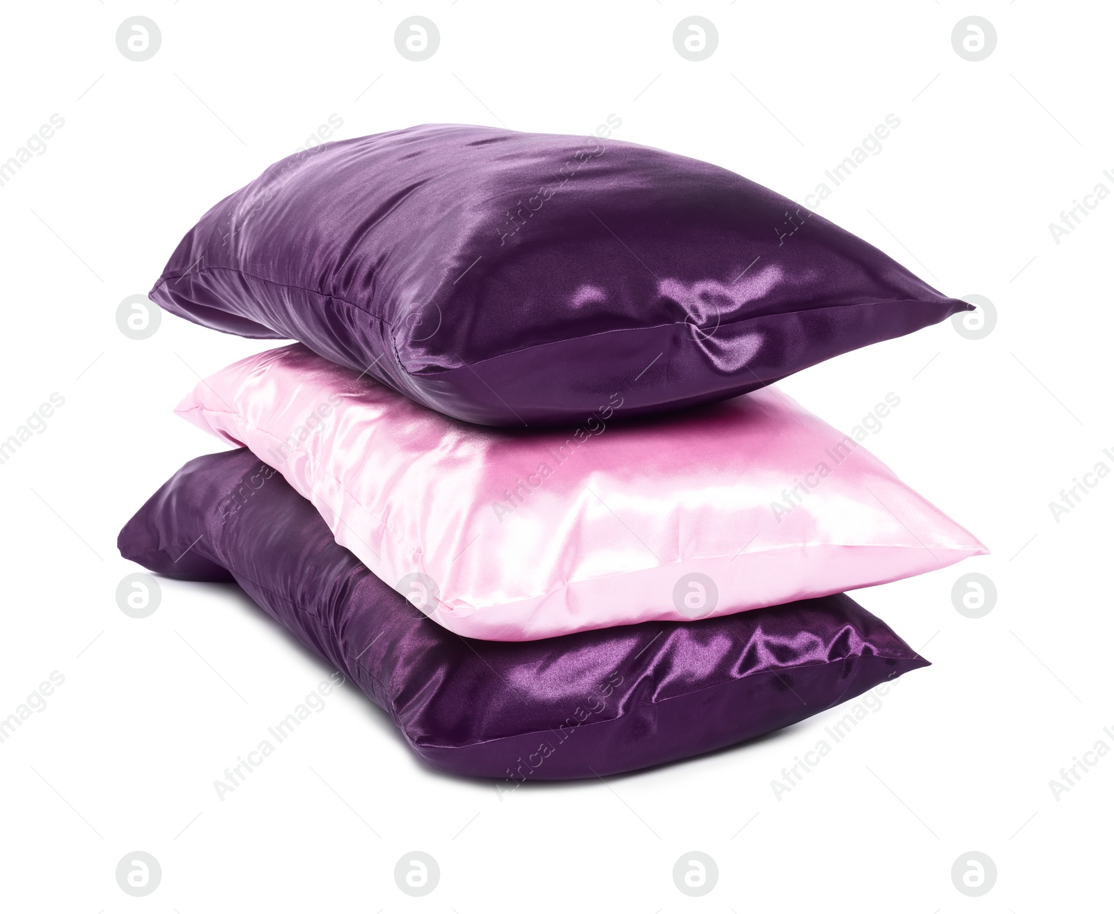 Pillows in pillowcases isolated on white. Silk bed linens Photo of Pillows in pillowcases isolated on white. Silk bed linens