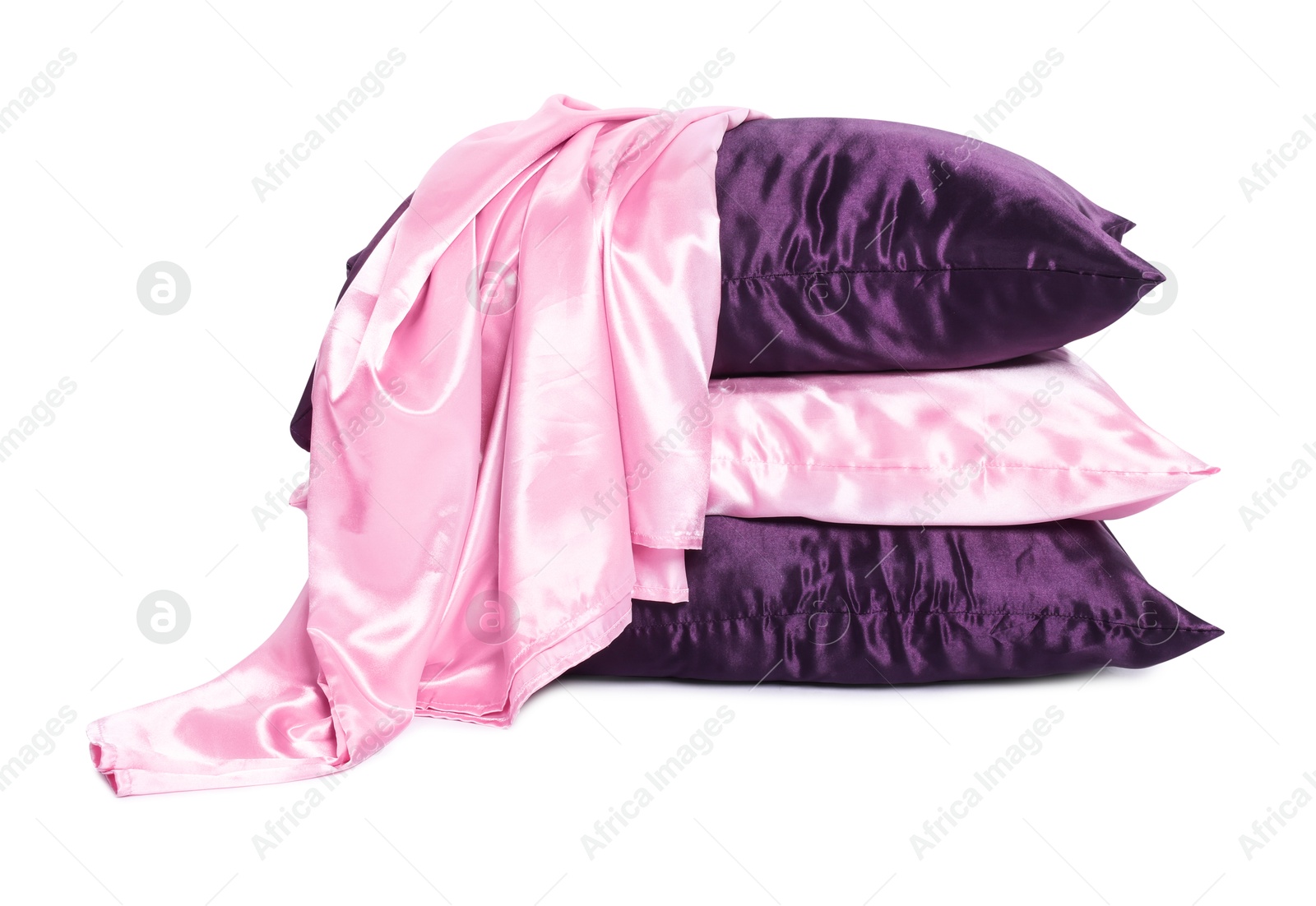 Pillows and silk bed linens isolated on white Photo of Pillows and silk bed linens isolated on white