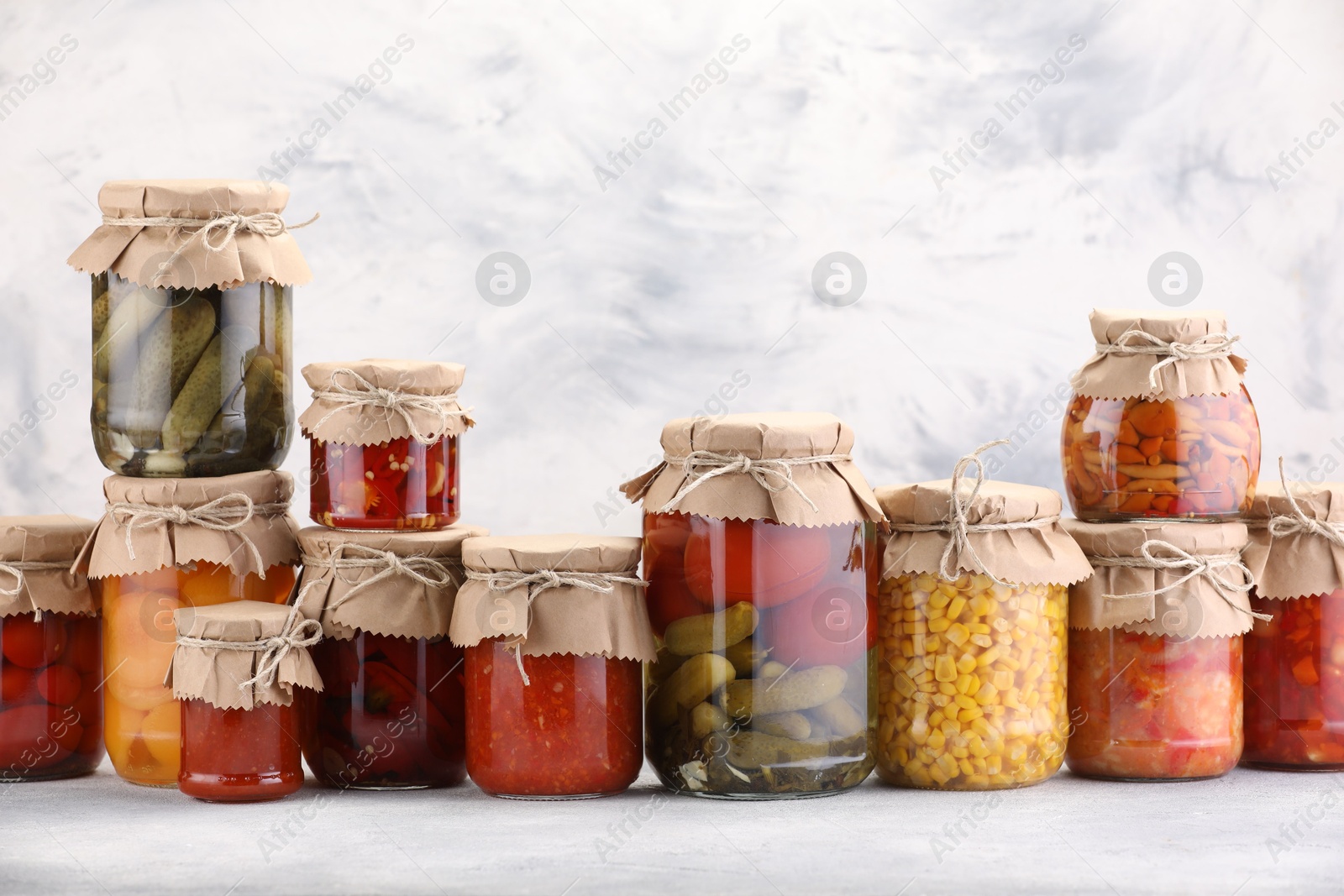 Many jars with different pickled products on light table. Space for text Photo of Many jars with different pickled products on light table. Space for text