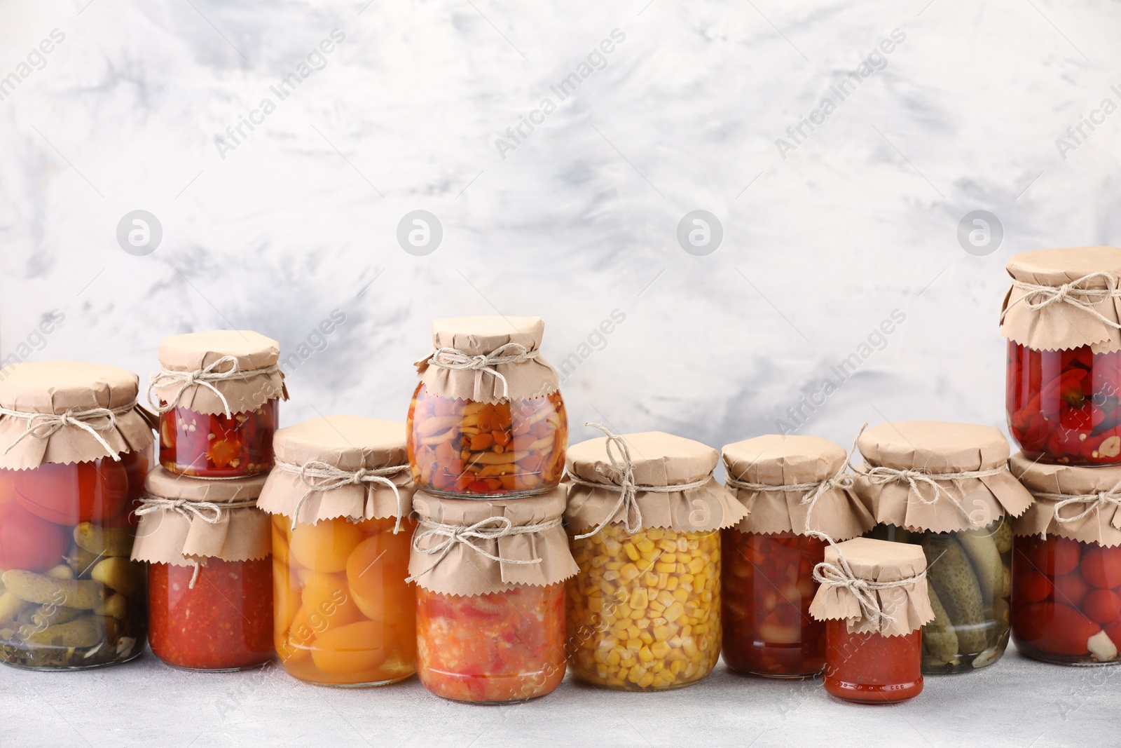 Many jars with different pickled products on light table. Space for text Photo of Many jars with different pickled products on light table. Space for text