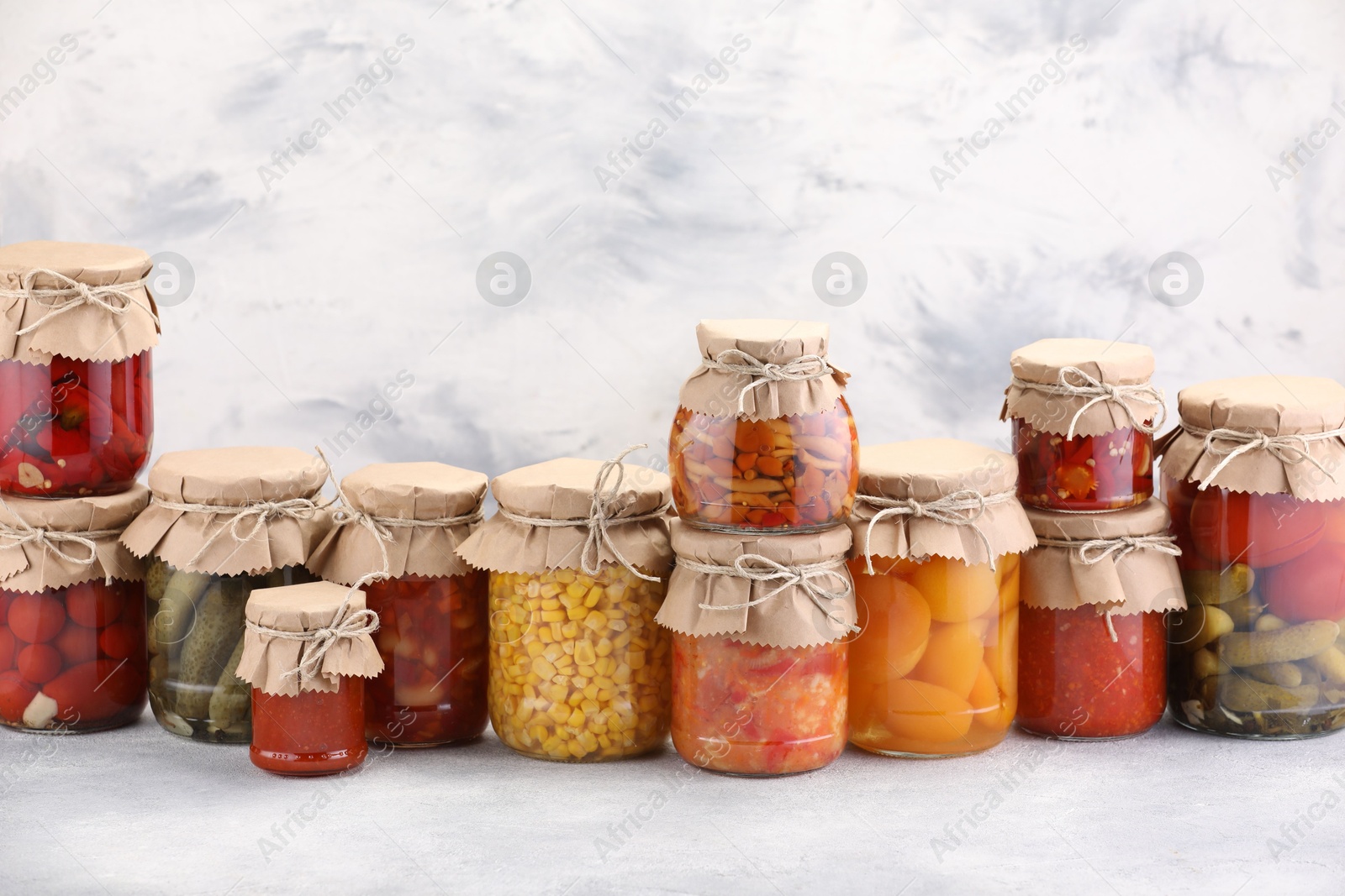 Many jars with different pickled products on light table. Space for text Photo of Many jars with different pickled products on light table. Space for text