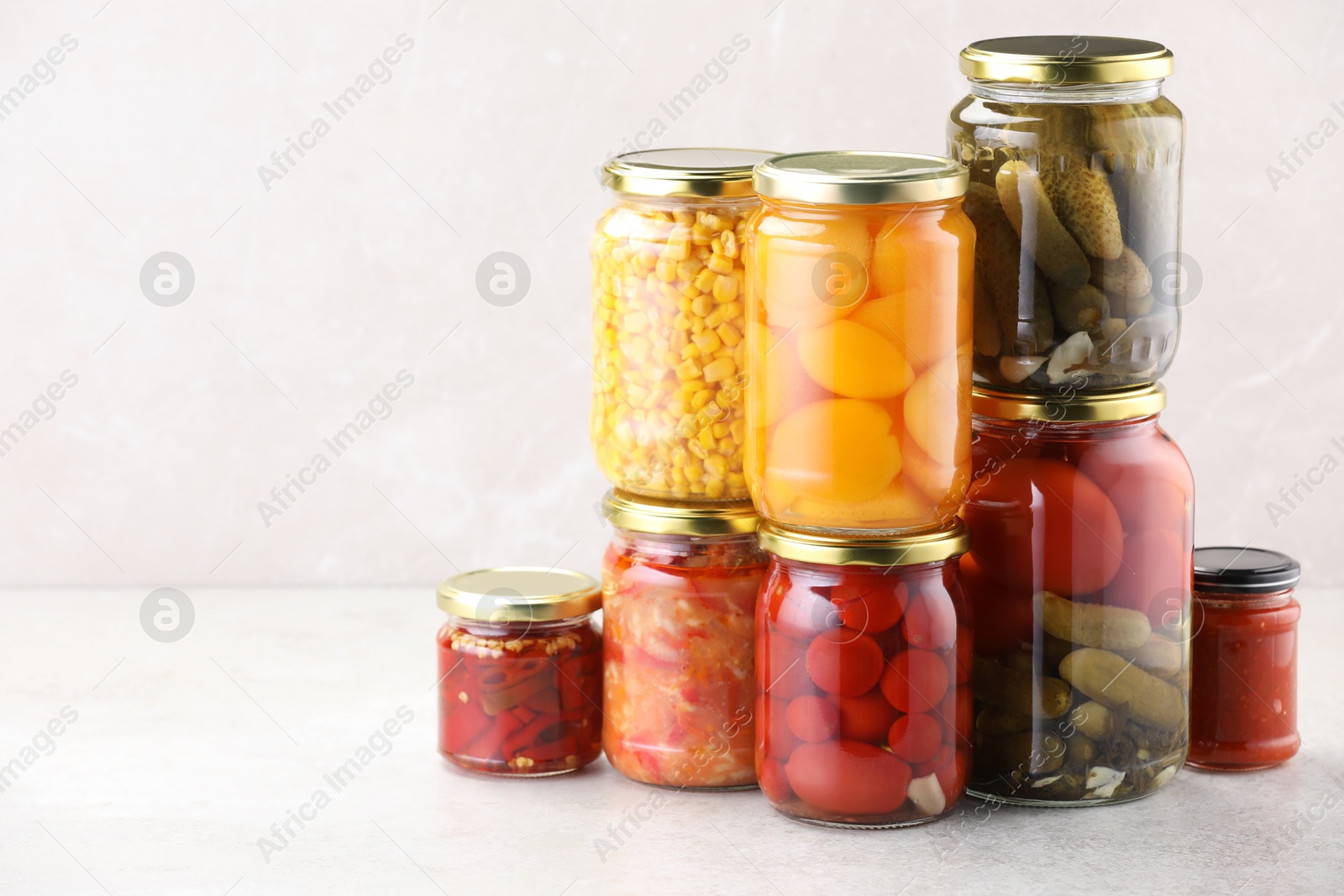 Many jars with different pickled products on light table. Space for text Photo of Many jars with different pickled products on light table. Space for text