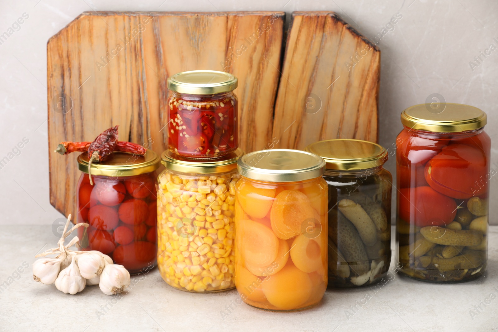 Many jars with different pickled products on light table Photo of Many jars with different pickled products on light table