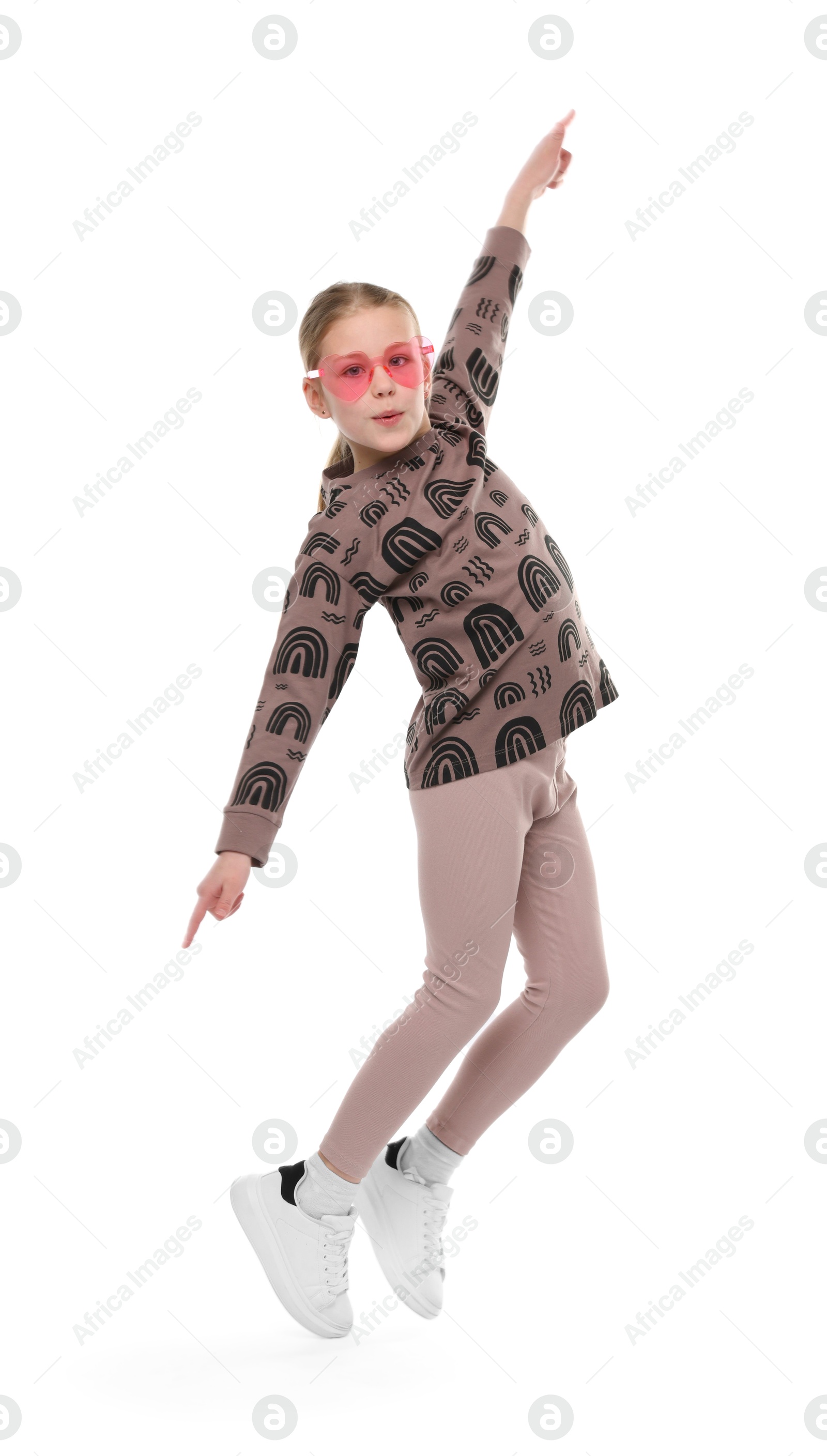 Girl in stylish clothes and sunglasses dancing on white background Photo of Girl in stylish clothes and sunglasses dancing on white background