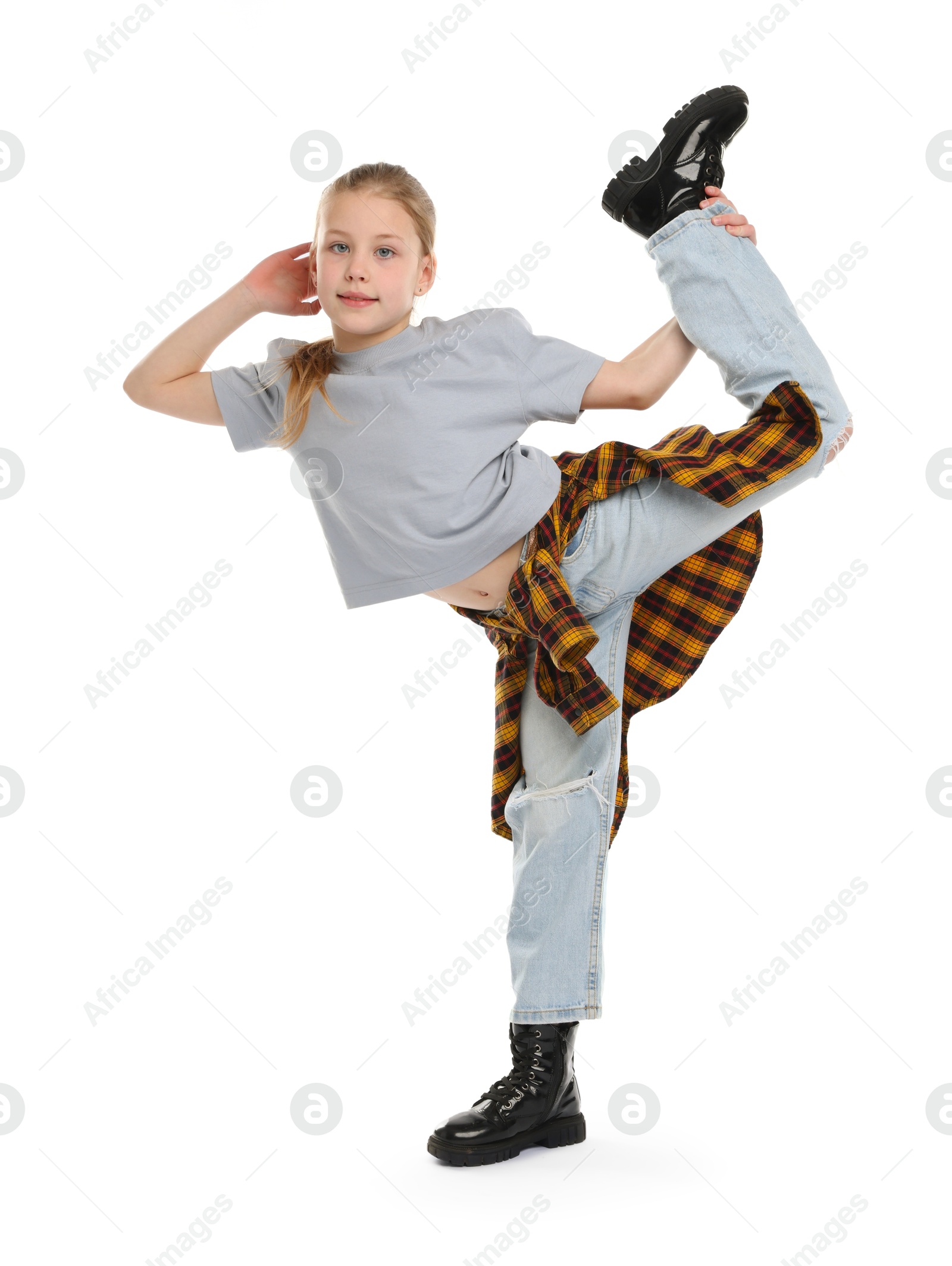 Girl in stylish clothes dancing on white background Photo of Girl in stylish clothes dancing on white background