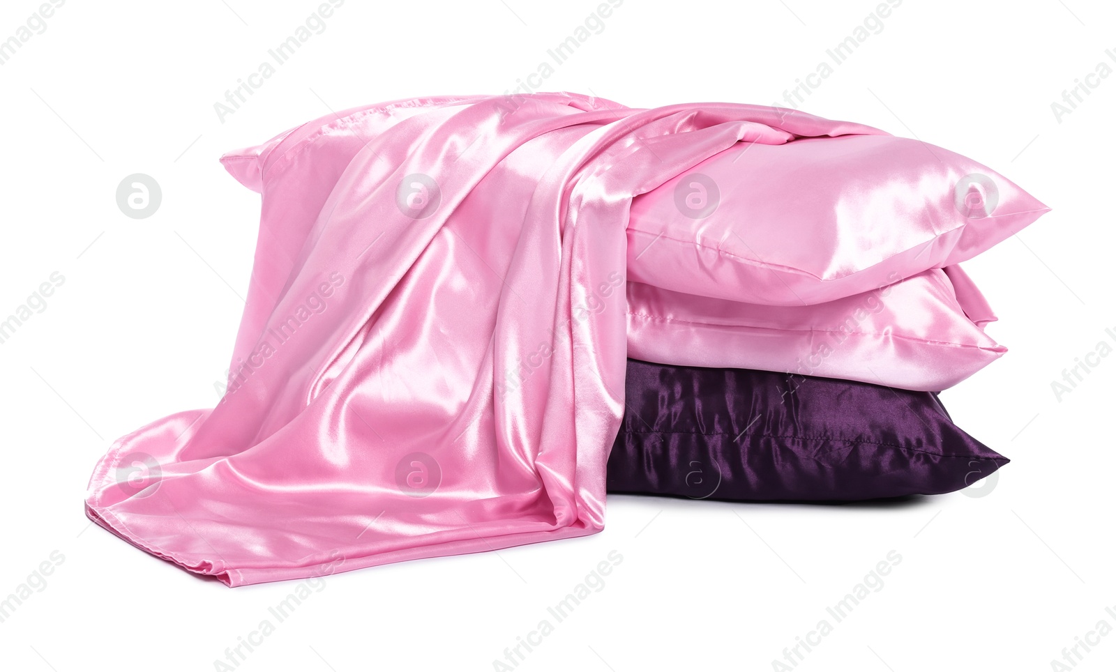 Pillows and silk bed linens isolated on white Photo of Pillows and silk bed linens isolated on white