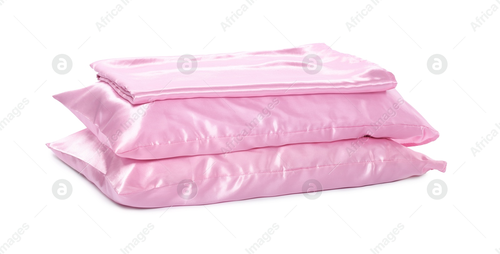 Pillows and silk bed linens isolated on white Photo of Pillows and silk bed linens isolated on white