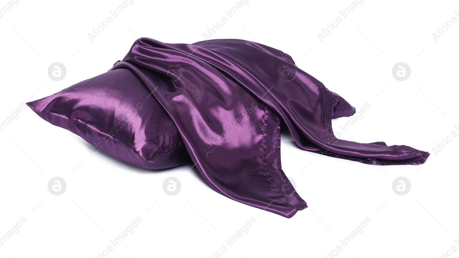 Pillow and silk bed linens isolated on white Photo of Pillow and silk bed linens isolated on white