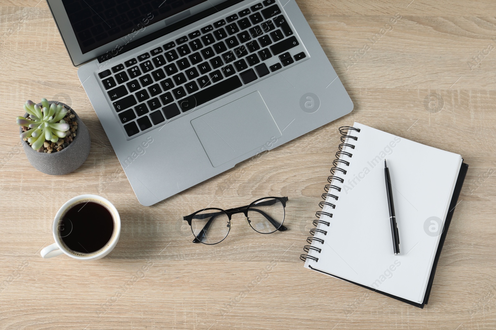 Flat lay composition with office supplies, laptop and cup of coffee on wooden table Photo of Flat lay composition with office supplies, laptop and cup of coffee on wooden table