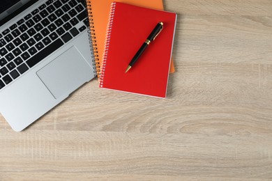 Photo of Office supplies and laptop on wooden table, flat lay. Space for text