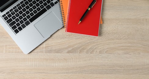 Photo of Office supplies and laptop on wooden table, flat lay. Space for text