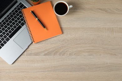 Photo of Flat lay composition with office supplies, laptop and cup of coffee on wooden table. Space for text