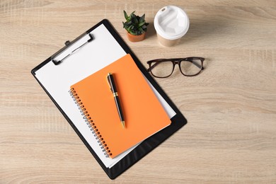Photo of Flat lay composition with office supplies, houseplant and takeaway paper cup on wooden table