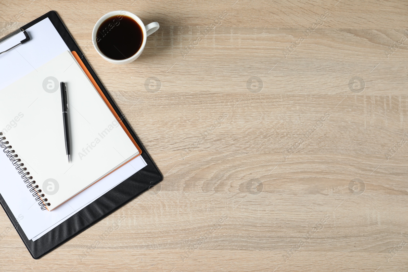 Office supplies and cup of coffee on wooden table, flat lay. Space for text Photo of Office supplies and cup of coffee on wooden table, flat lay. Space for text