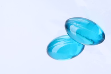 Photo of Collagen capsules on white background, above view. Space for text